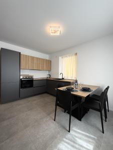 a kitchen with a table and chairs in a room at Z&N Apartment in Levico Terme