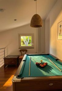 a room with a pool table in a room with at Poggio Madonna in Campagnatico