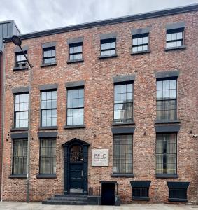 a brick building with a black door and windows at EPIC Apart Hotel, Duke Street, Central Liverpool Apartments Near Liverpool ONE in Liverpool