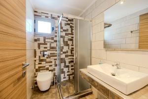 a bathroom with a sink and a toilet at Studios Sotiria in Limenas