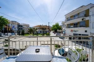 a table and chairs on the balcony of a building at Studios Sotiria in Limenas