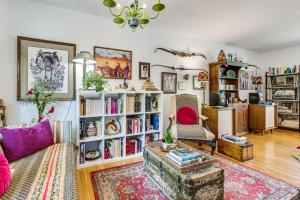 a living room with a couch and book shelves at Eclectic Multi-Level Charmer! 2 Mi to CU Boulder in Boulder