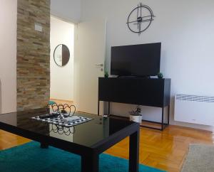 a living room with a coffee table and a flat screen tv at Agape C-52 in Trebinje +30 photos
