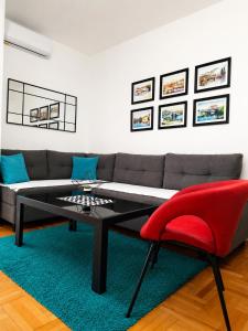 a living room with a couch and a red chair at Agape C-52 in Trebinje