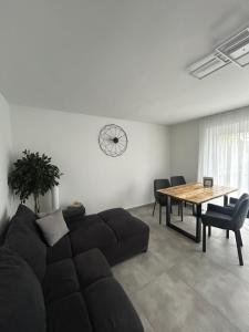 a living room with a couch and a table at MelSun Apartment in Melsungen +31 photos