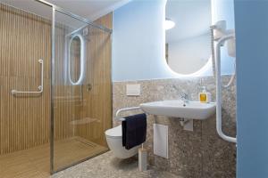 a bathroom with a shower and a toilet and a sink at Marina Apartamenty ChKŻ in Charzykowy +36 photos
