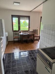 a kitchen with a table and chairs in a room at Breze Away in Tuzla