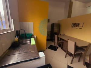 a kitchen with a counter and a table and chairs at Diadema Studio - Apt 11 in Diadema +16 photos