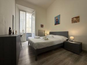 a bedroom with a bed and a large window at LA VIOLETTA DI PARMA // DEL DUCATO in Parma
