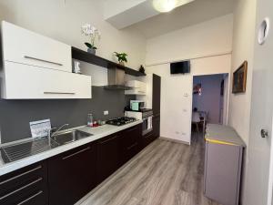 a kitchen with a sink and a counter at LA VIOLETTA DI PARMA // DEL DUCATO in Parma +28 photos