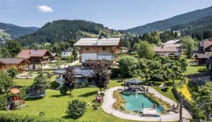 an aerial view of a resort with a swimming pool at Chalets Wagrain in Wagrain +11 photos