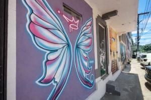 a mural of a butterfly painted on the side of a building at Solar Clefis in Vitória