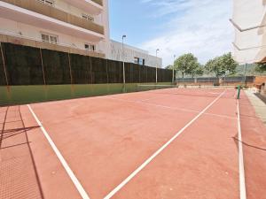 a tennis court in front of a building at Sea&Kids in Malgrat de Mar