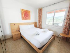 a bedroom with a bed and a window at Sea&Kids in Malgrat de Mar +23 photos