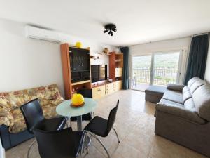 a living room with a couch and a table with chairs at Sea&Kids in Malgrat de Mar