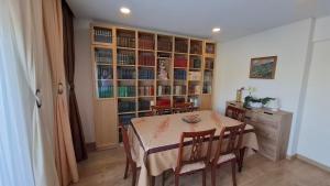 a dining room with a table and a book shelf at Thouse Fontainhas in Cascais