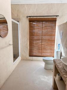 a bathroom with a toilet and a sink at Esperanza Wood Room in George