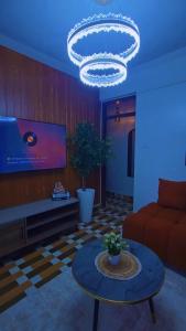 a living room with a couch and a chandelier at CB Luxury in Kisii