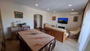 a living room with a table and a living room with a couch at Thouse Fontainhas in Cascais