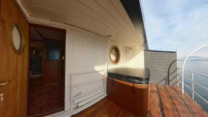 a balcony of a cruise ship with a door at Piroscafo Lombardia in Arona +16 photos