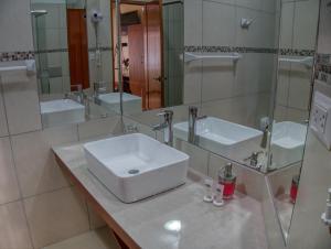 a bathroom with a sink and a mirror at Hotel Sol Natura in Ollantaytambo