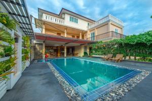 an image of a swimming pool in a house at The Canal Ratchaburi in Ratchaburi