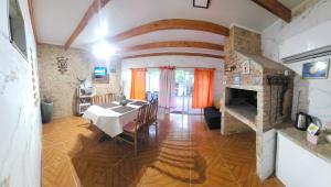 a dining room with a table and a fireplace at La Quimera a pasos de la playa in Atlántida