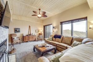 a living room with a couch and a table at Pool Access! Ski-In/Out Sugar Mtn Gem w/ Views in Sugar Mountain