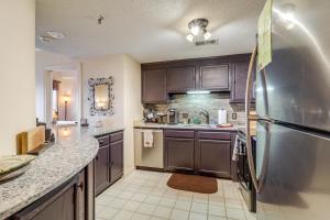 a kitchen with brown cabinets and a stainless steel refrigerator at Pool Access! Ski-In/Out Sugar Mtn Gem w/ Views in Sugar Mountain