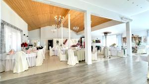 a banquet hall with white tables and chairs at Willa Opal , 250 m do morza in Grzybowo +165 photos