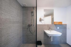 a bathroom with a sink and a shower at Villa Beaulieu in St. Moritz +63 photos