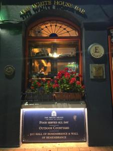 a building with a window with flowers on it at The White House in Kinsale