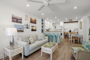 a living room with a couch and a table at Gulf Winds Resort by Travel Resort Services in St. Pete Beach