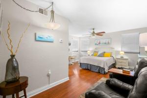a living room with a bed and a couch at Gulf Winds Resort by Travel Resort Services in St. Pete Beach +258 photos