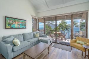 a living room with a couch and a table at 401 Maalaea Banyans in Wailuku +17 photos