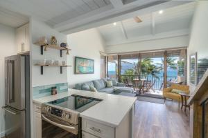 a kitchen and living room with a view of the ocean at 401 Maalaea Banyans in Wailuku
