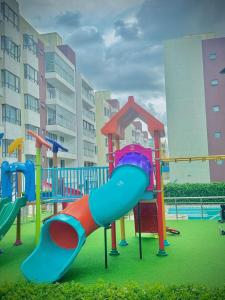 a playground with a slide in a park at Nene Homes in Marimbeti