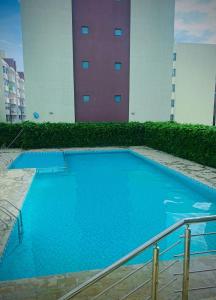 a large blue swimming pool in front of a building at Nene Homes in Marimbeti