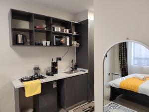 a room with a bed and a sink and a kitchen at Nene Homes in Marimbeti +24 photos