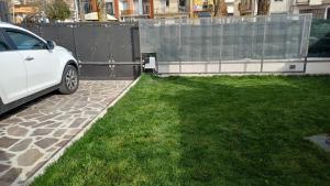 a white car parked in a yard next to a fence at il Biscottino in Castel di Sangro