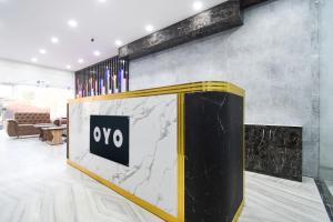 a lobby with a marble counter with a sign on it at Hotel O Radha Krishna Residency in Nagri +26 photos