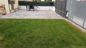 a patio with grass and a table and a fence at il Biscottino in Castel di Sangro +45 photos
