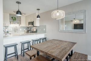 a kitchen with a wooden table and stools at 214 Kihei Holiday in Kihei