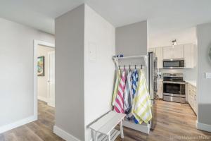 a kitchen with white walls and a chair in a room at 214 Kihei Holiday in Kihei +17 photos