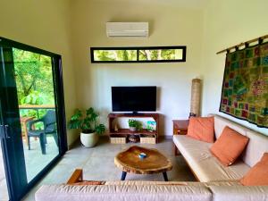 a living room with a couch and a table at Tierra Encantada in Dominicalito