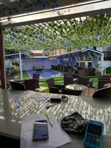 a room with tables and chairs and a pool at DE Lounge Inn in Ikorodu