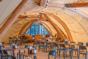 a dining room with tables and chairs in a tent at Under Canvas Yosemite in Groveland