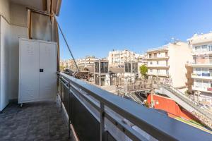 a balcony with a door and a view of a city at Gkr Luxury Apartments Metro Petralona in Athens