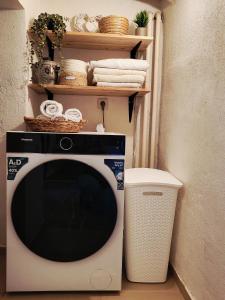 a microwave in a room with a shelf with towels at Brick House in Fürstenfeld