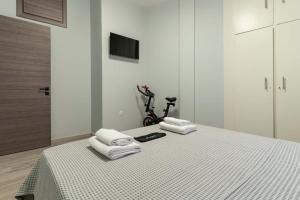 a bedroom with a bed with towels on top of it at Gkr Luxury Apartments Metro Petralona in Athens +85 photos